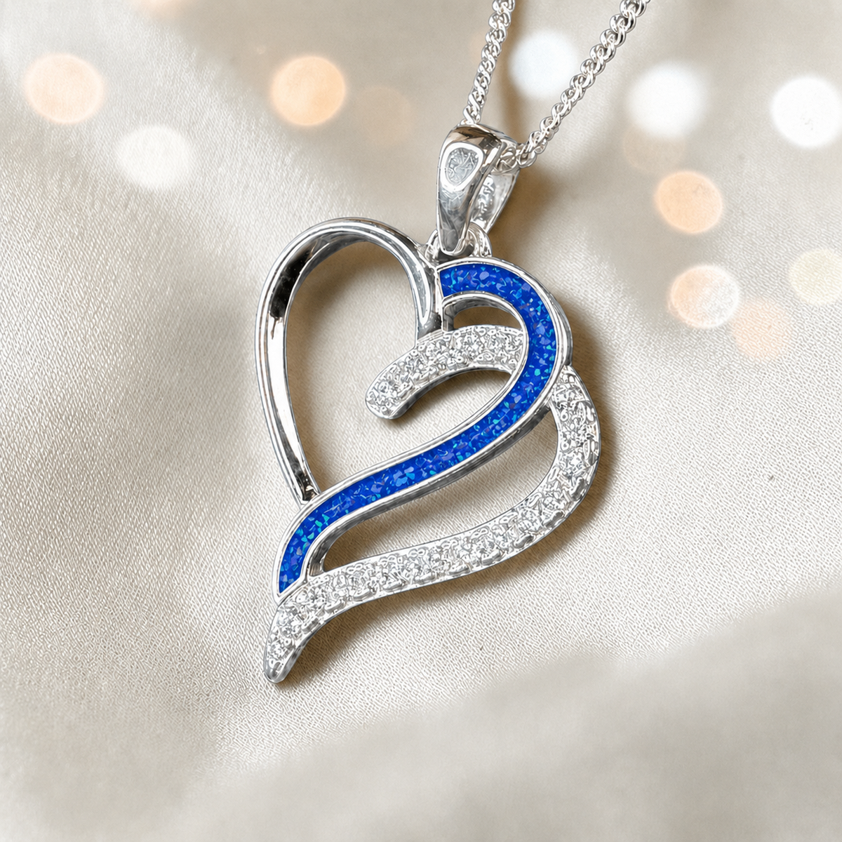 Olive Heart shaped memorial ashes pendant with CZ stones and royal blue resin. handcrafted in Lancashire, UK.