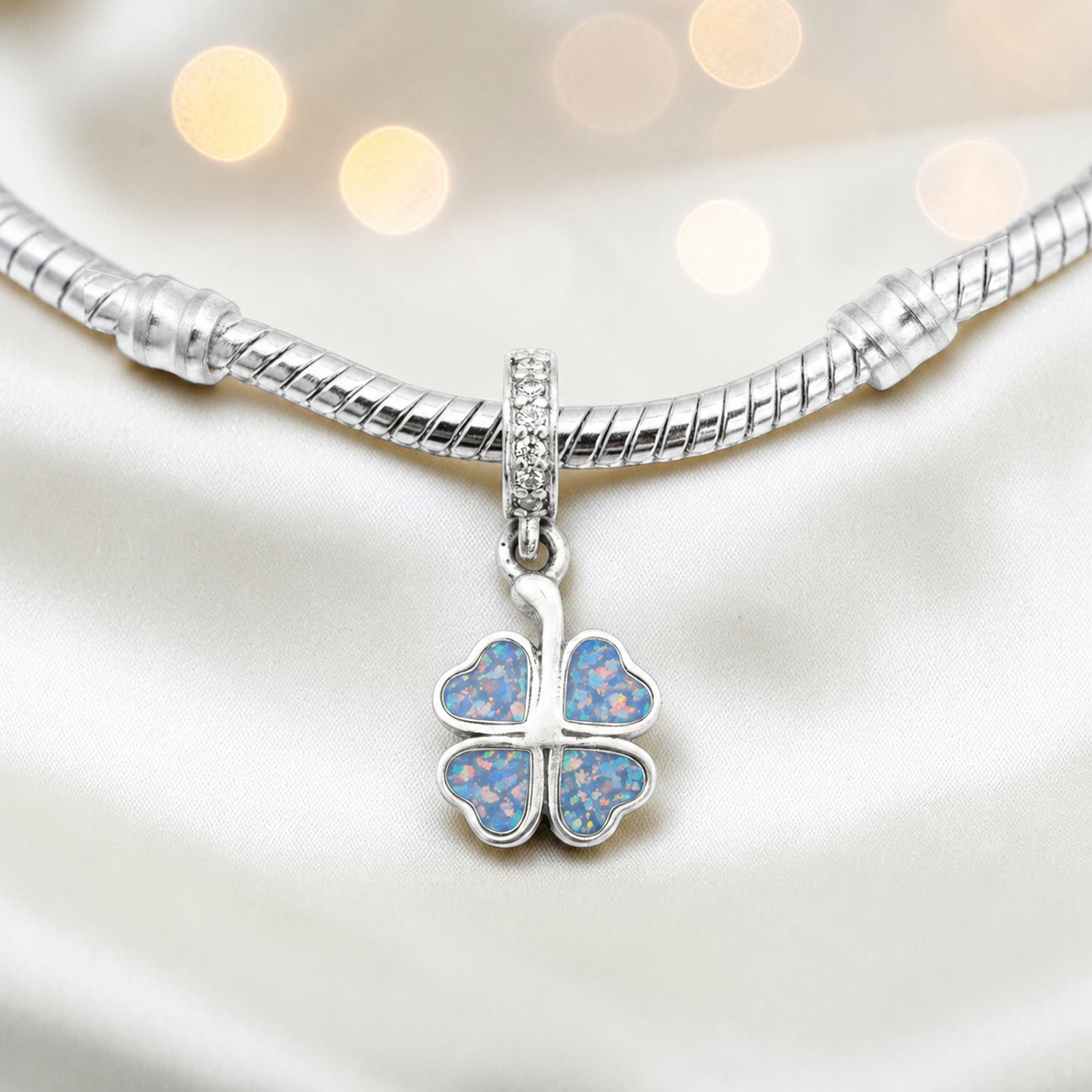 Baby blue sterling silver clover dangle ashes memorial charm, handcrafted in Lancashire by keepsake memorial