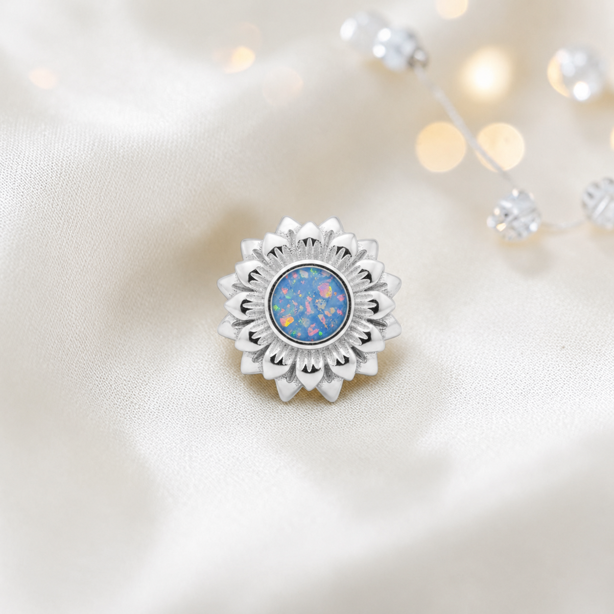 Baby blue sterling silver sunflower ashes memorial charm, handcrafted in Lancashire by keepsake memorial