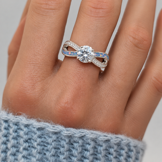Keepsake Memorial Silver Infinity Ashes Ring in baby blue on hand - Handcrafted in the UK