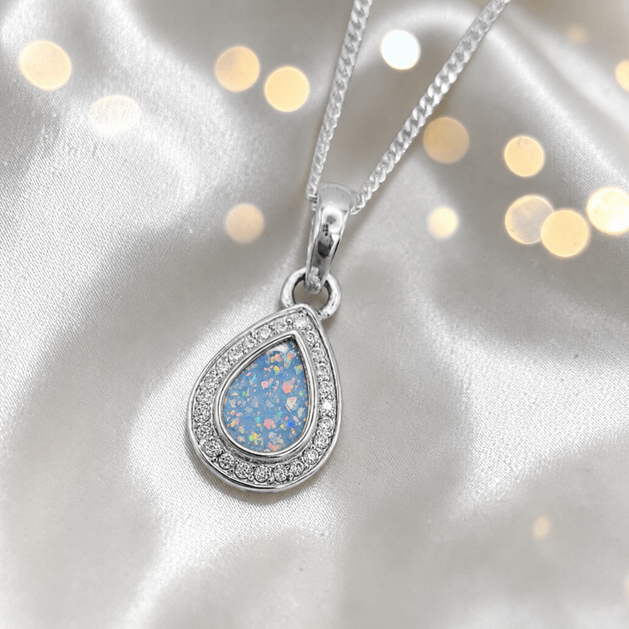 seraph glow pear shaped ashes pendant with CZ in baby blue, handcrafted in Lancashire UK