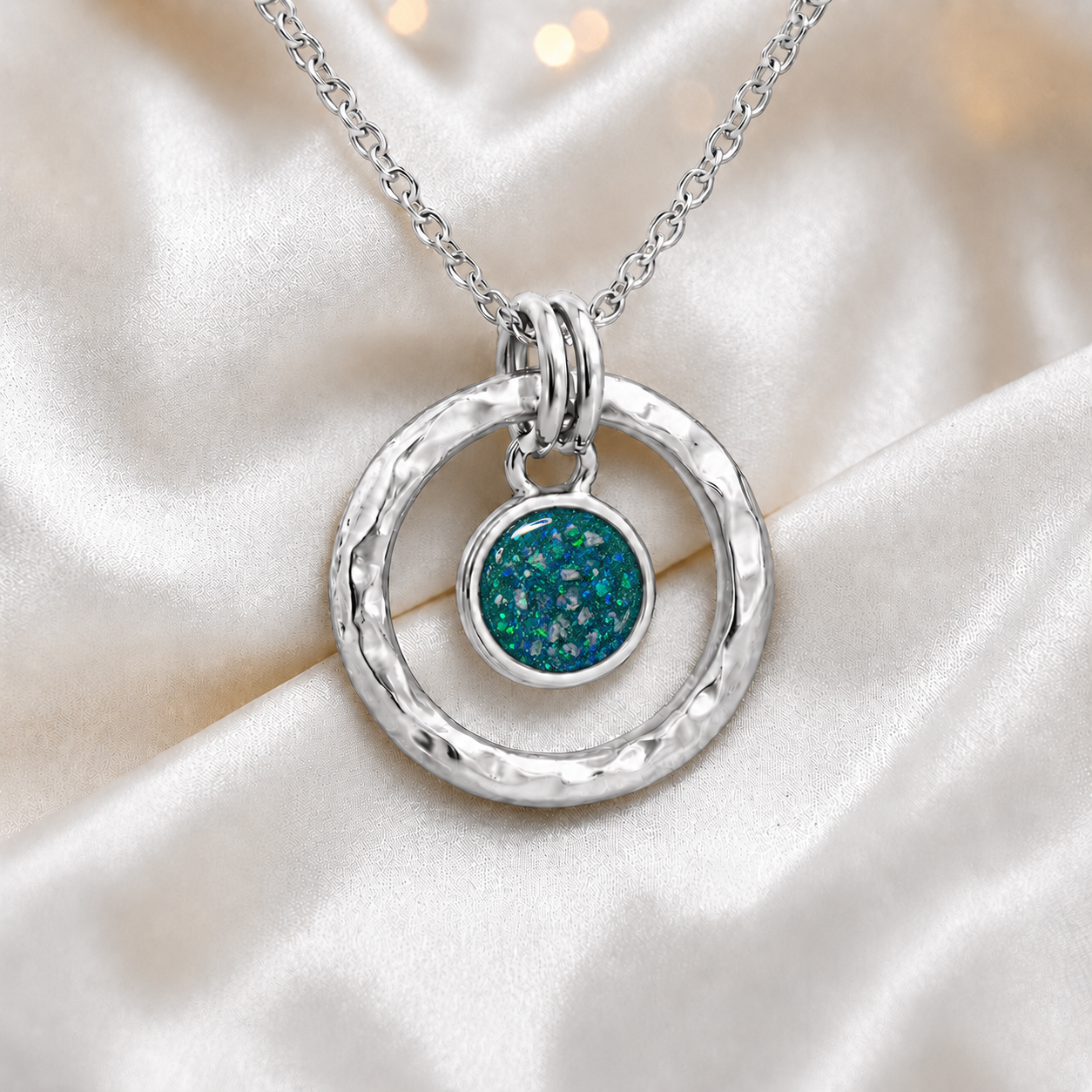 Teal mist hammered hollow circle sterling silver memorial pendant, handcrafted in Lancashire UK by Keepsake Memorial Jewellery