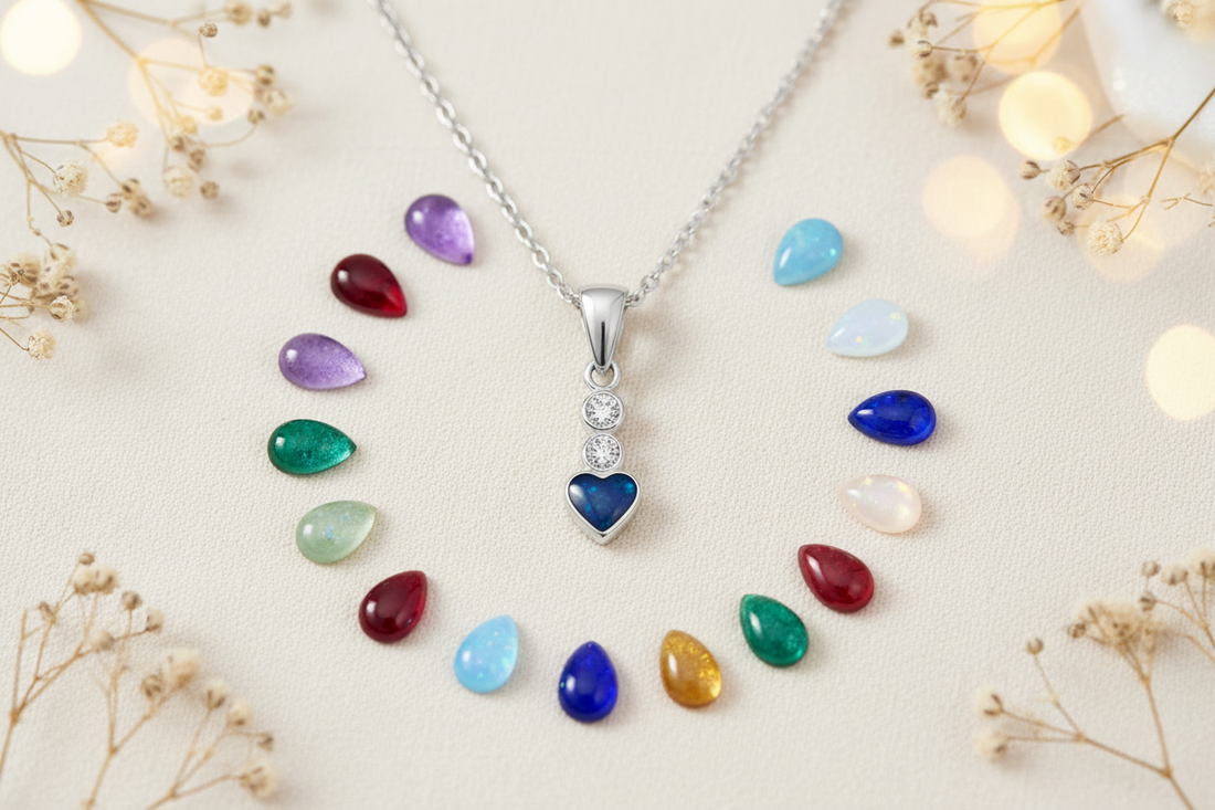 Silver heart shaped pendant with birthstone colours around it on a cream background, handcrafted in Lancashire UK by Keepsake Memorial Jewellery