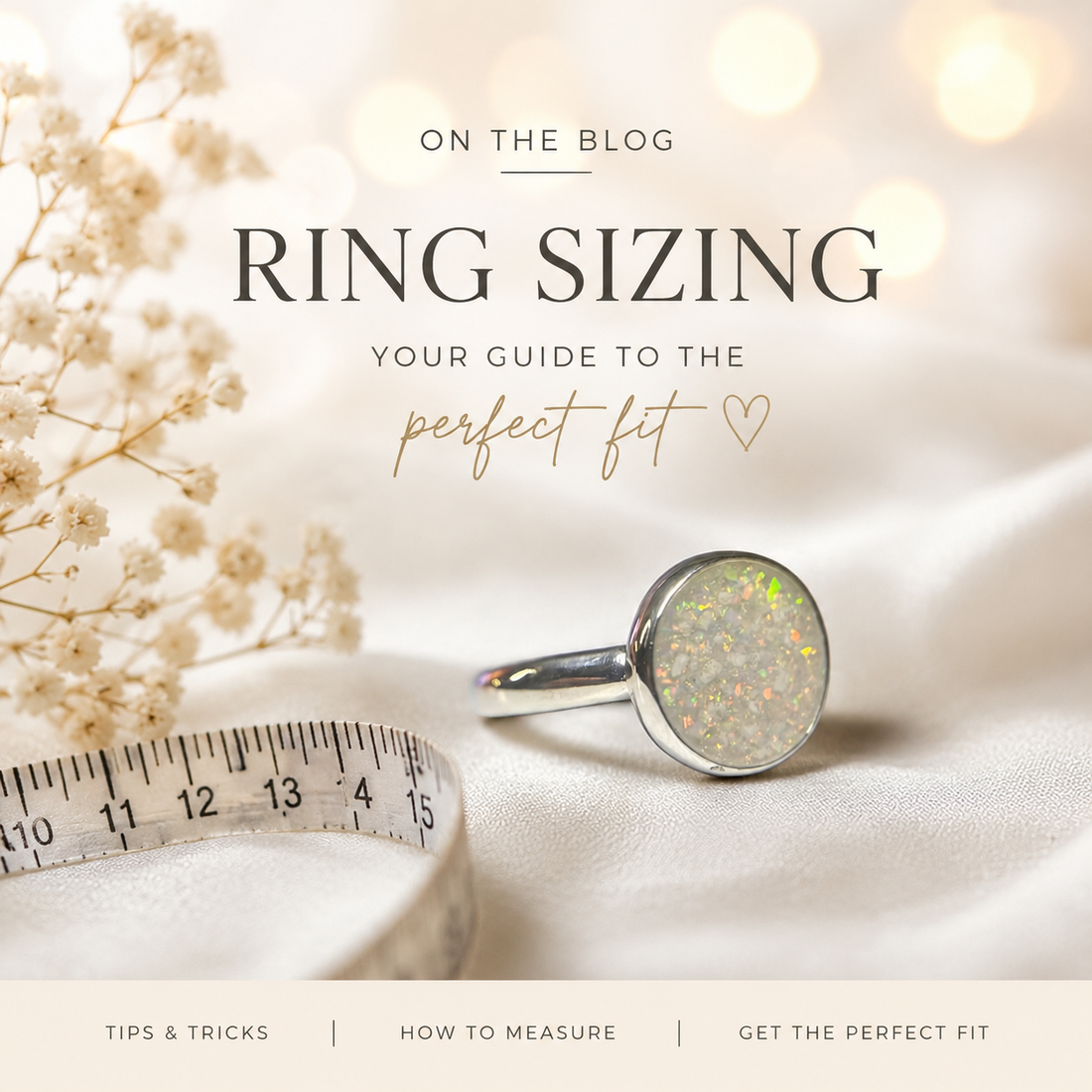 flat lay of ring sizing tools including a ring sizer and measuring tape, alongside a sterling silver memorial ring on a soft neutral background