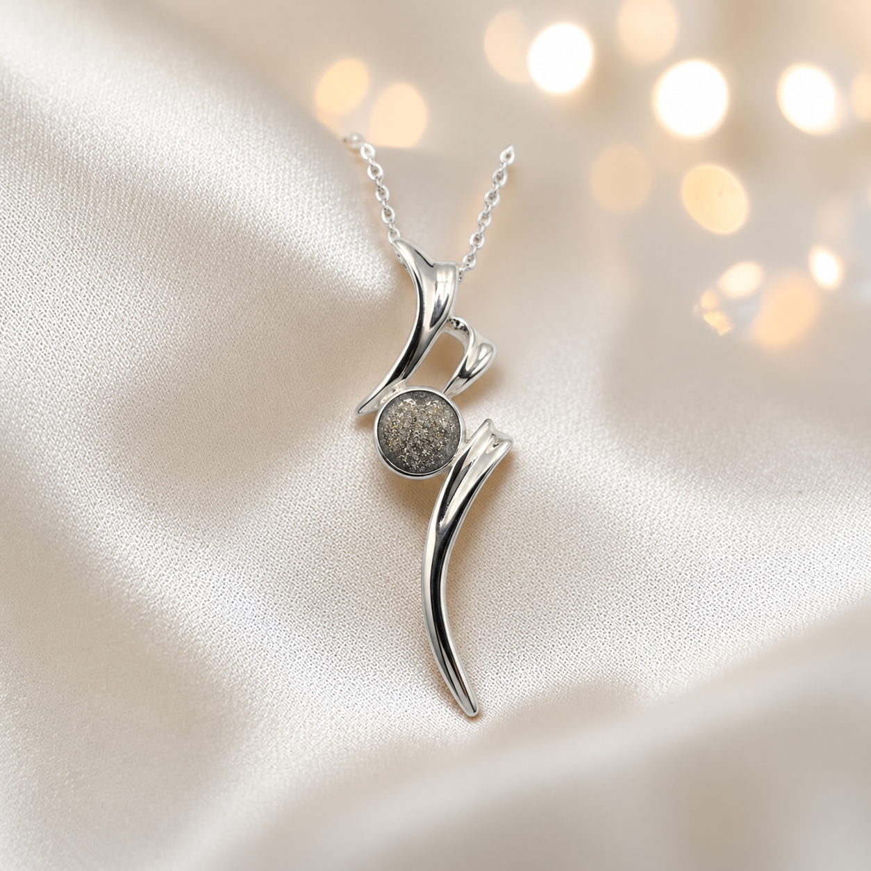 Abstract silver memorial ashes pendant in natural ash, handcrafted in Lancashire UK