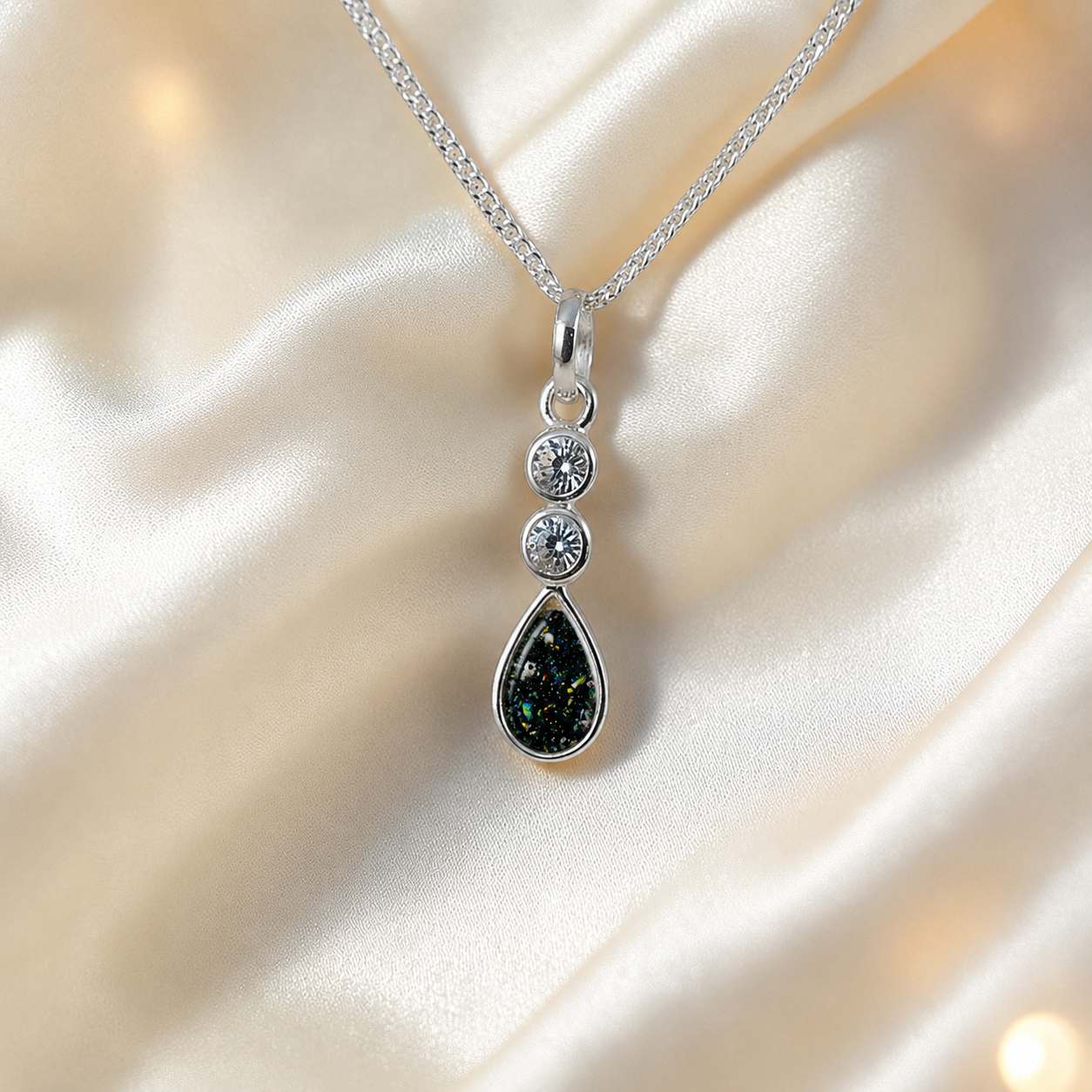 Acrux small tear drop CZ ashes pendant in black flame, handcrafted in Lancashire UK