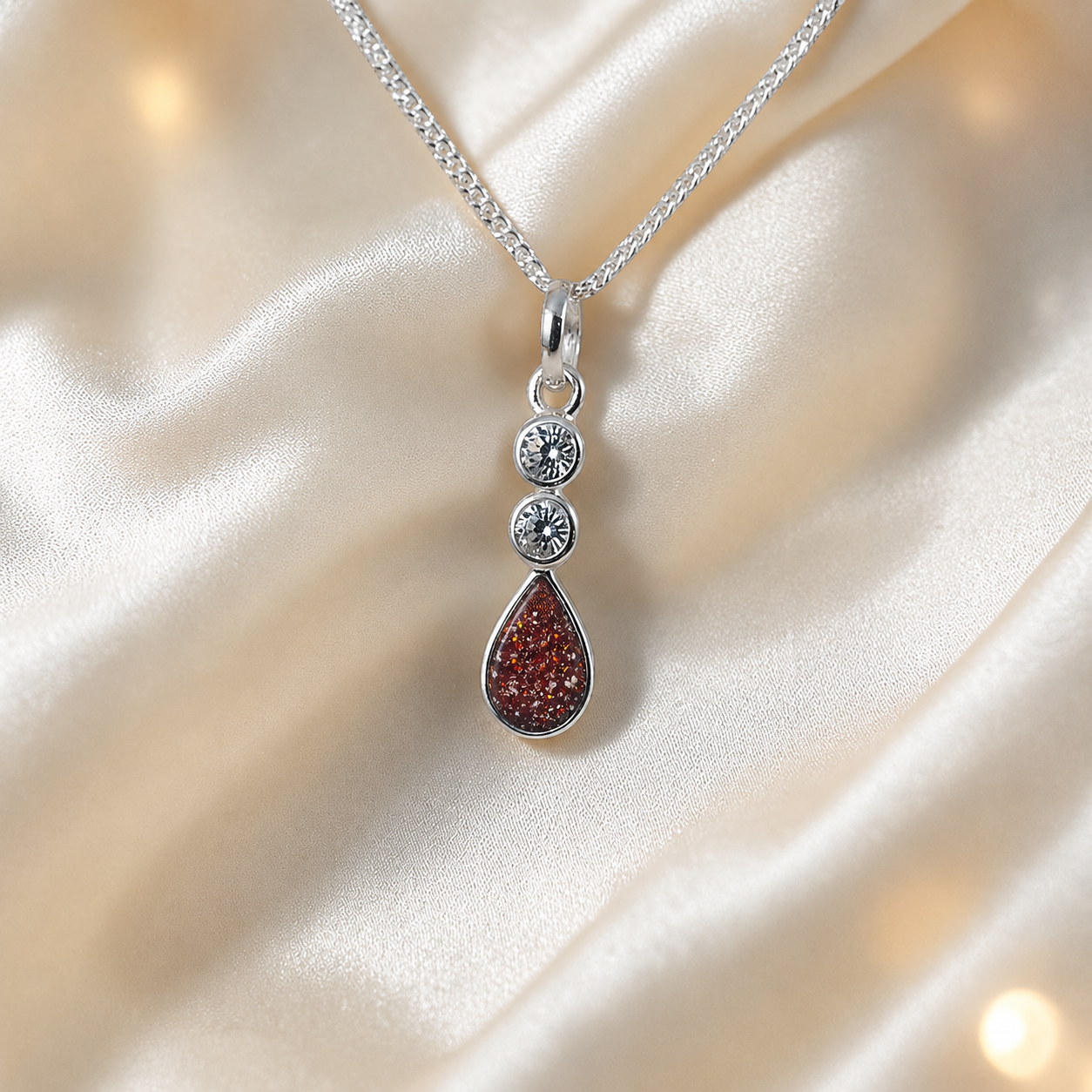 Acrux small tear drop CZ ashes pendant in ruby red, handcrafted in Lancashire UK