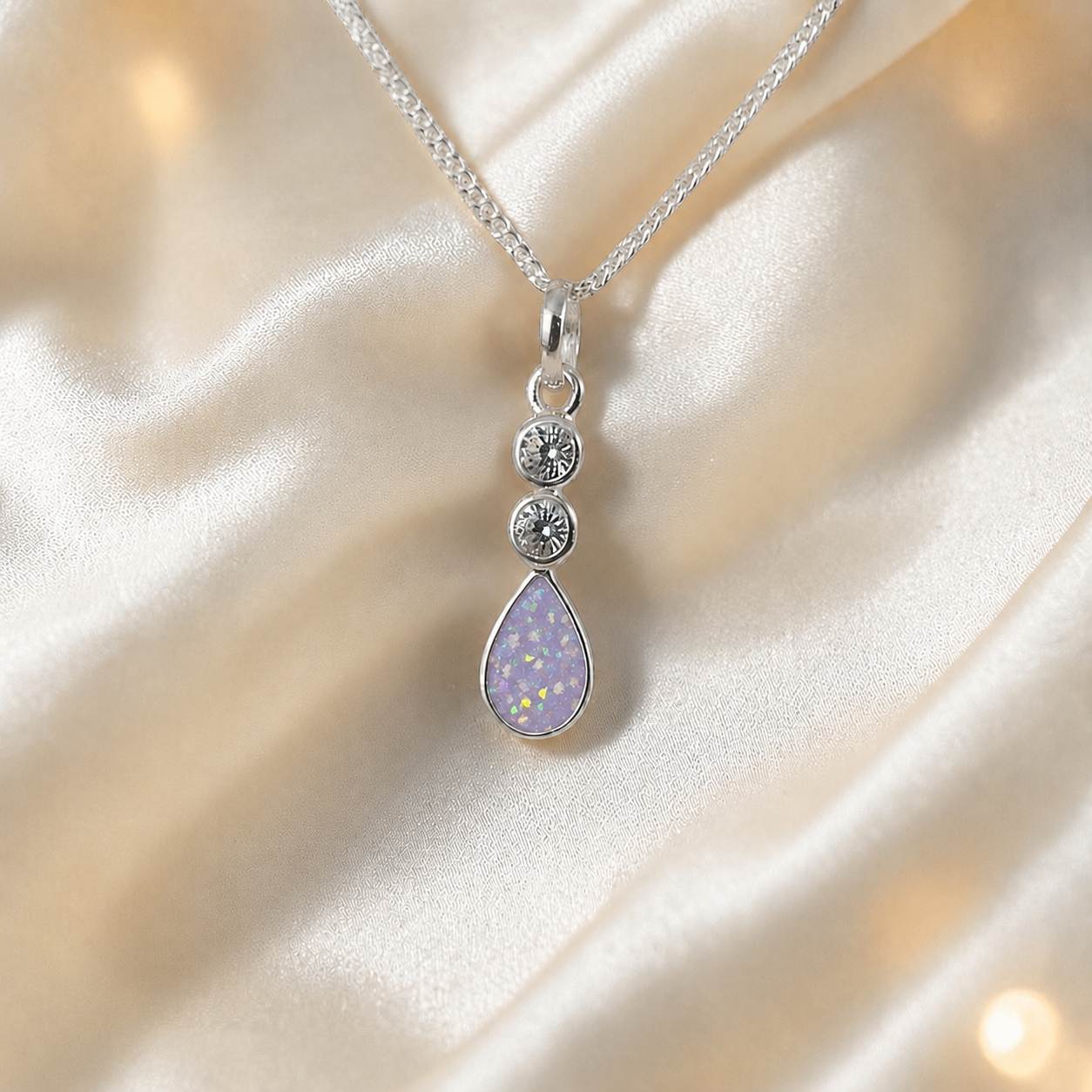 Acrux small tear drop CZ ashes pendant in unicorn purple, handcrafted in Lancashire UK