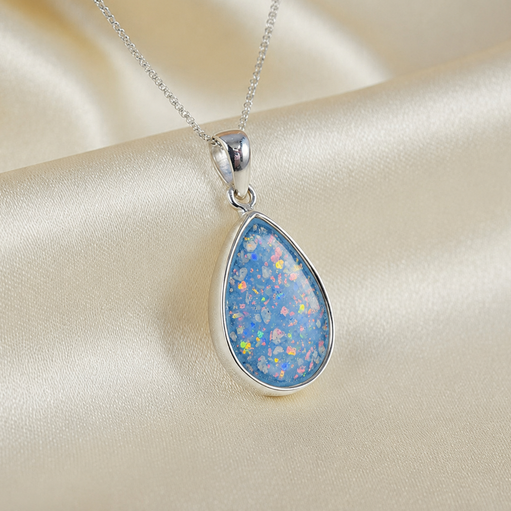 Alcyone pear shaped ashes pendant in baby blue, handcrafted in Lancashire UK - by Keepsake Memorial Jewellery
