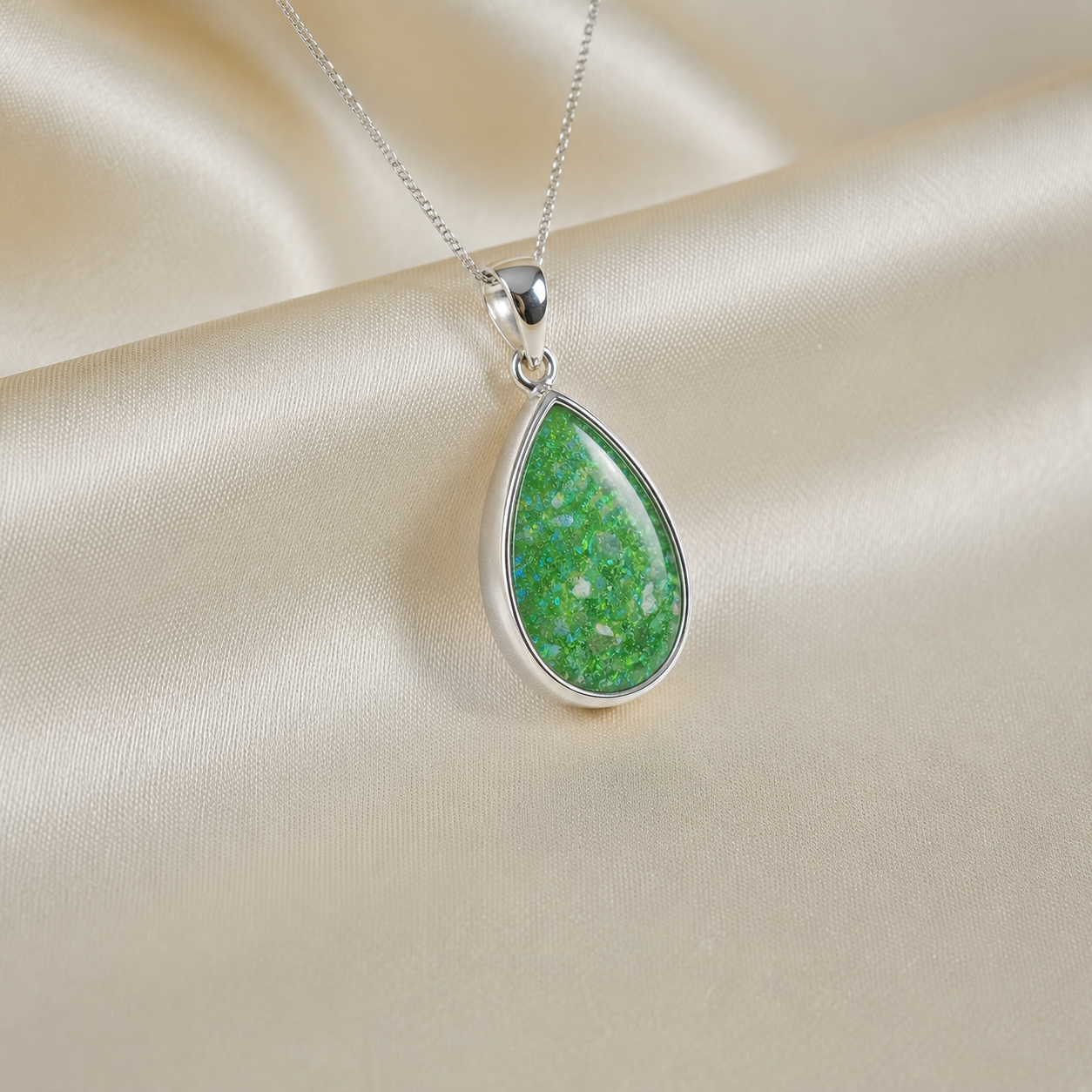 Alcyone pear shaped ashes pendant in fruit green, handcrafted in Lancashire UK - by Keepsake Memorial Jewellery