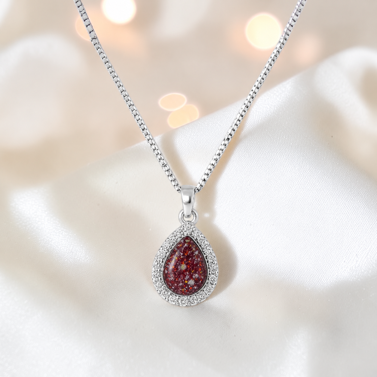 Almara teardrop dainty CZ ashes pendant in ruby red, handcrafted in Lancashire UK - by Keepsake Memorial Jewellery