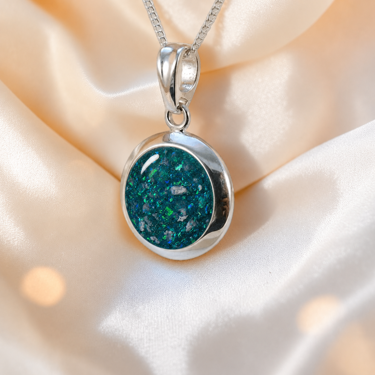 Altair round ashes pendant in teal mist, handcrafted in Lancashire UK