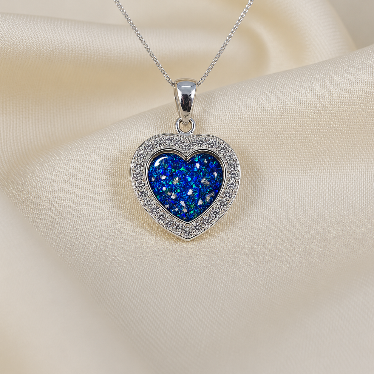 Antara Silver heart CZ shaped memorial pendant in sapphire glow, handcrafted in Lancashire UK