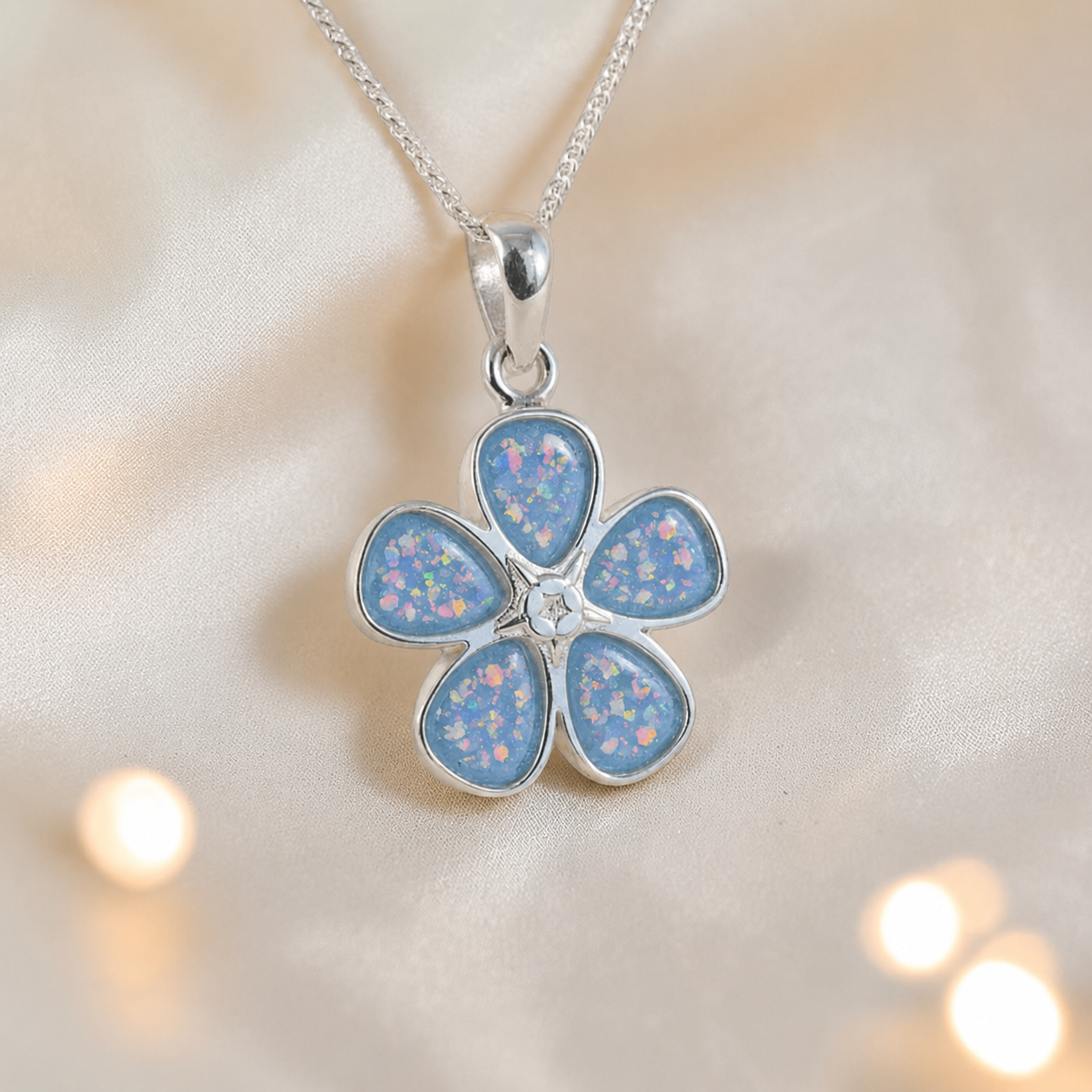 Arctura flower shaped ashes pendant in baby blue, handcrafted in Lancashire UK