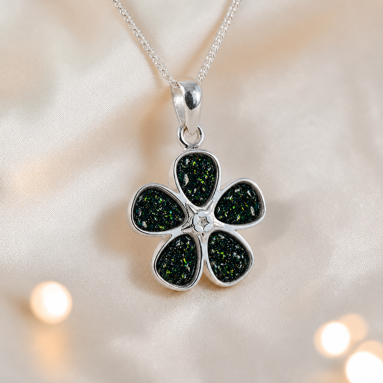Arctura flower shaped ashes pendant in black flame, handcrafted in Lancashire UK