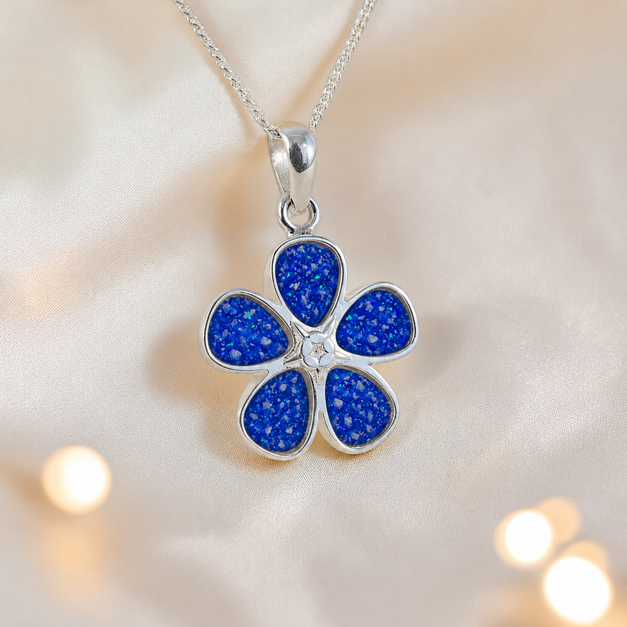 Arctura flower shaped ashes pendant in royal blue, handcrafted in Lancashire UK