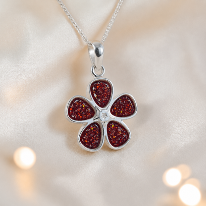 Arctura flower shaped ashes pendant in ruby red, handcrafted in Lancashire UK