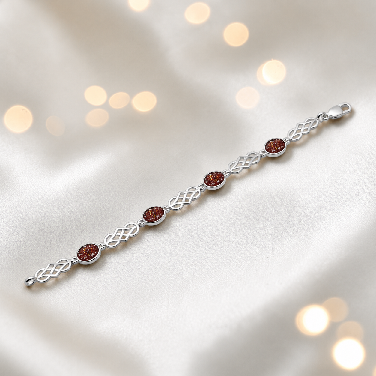 Asteria Bracelet — silver Celtic-style ashes memorial bracelet in ruby red, handcrafted in Lancashire, UK