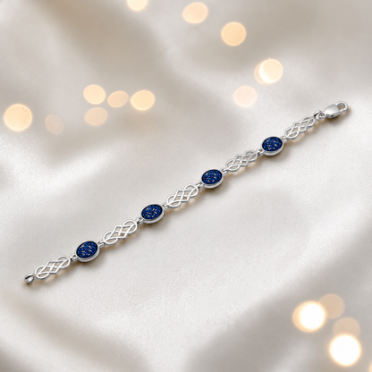 Asteria Bracelet — silver Celtic-style ashes memorial bracelet in sapphire glow, handcrafted in Lancashire, UK