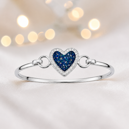 Auriga Heart Bangle — silver heart ashes memorial CZ bangle in sapphire glow, handcrafted in Lancashire, UK - by Keepsake Memorial Jeweller