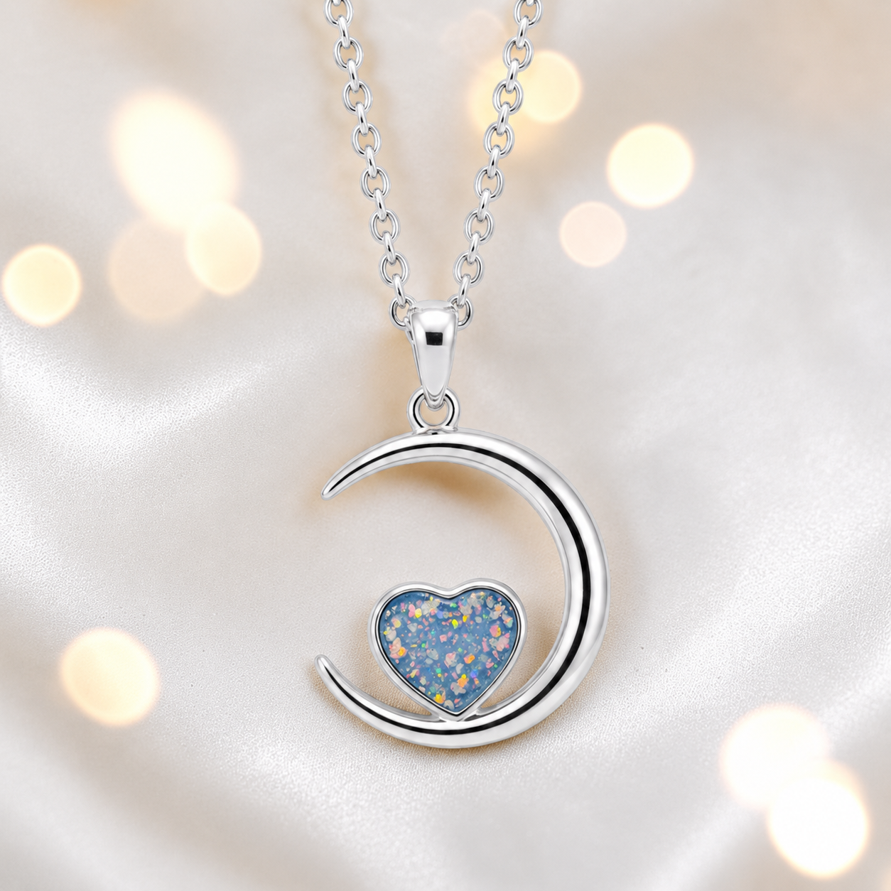 Aveline heart moon ashes pendant in baby blue, handcrafted in Lancashire UK