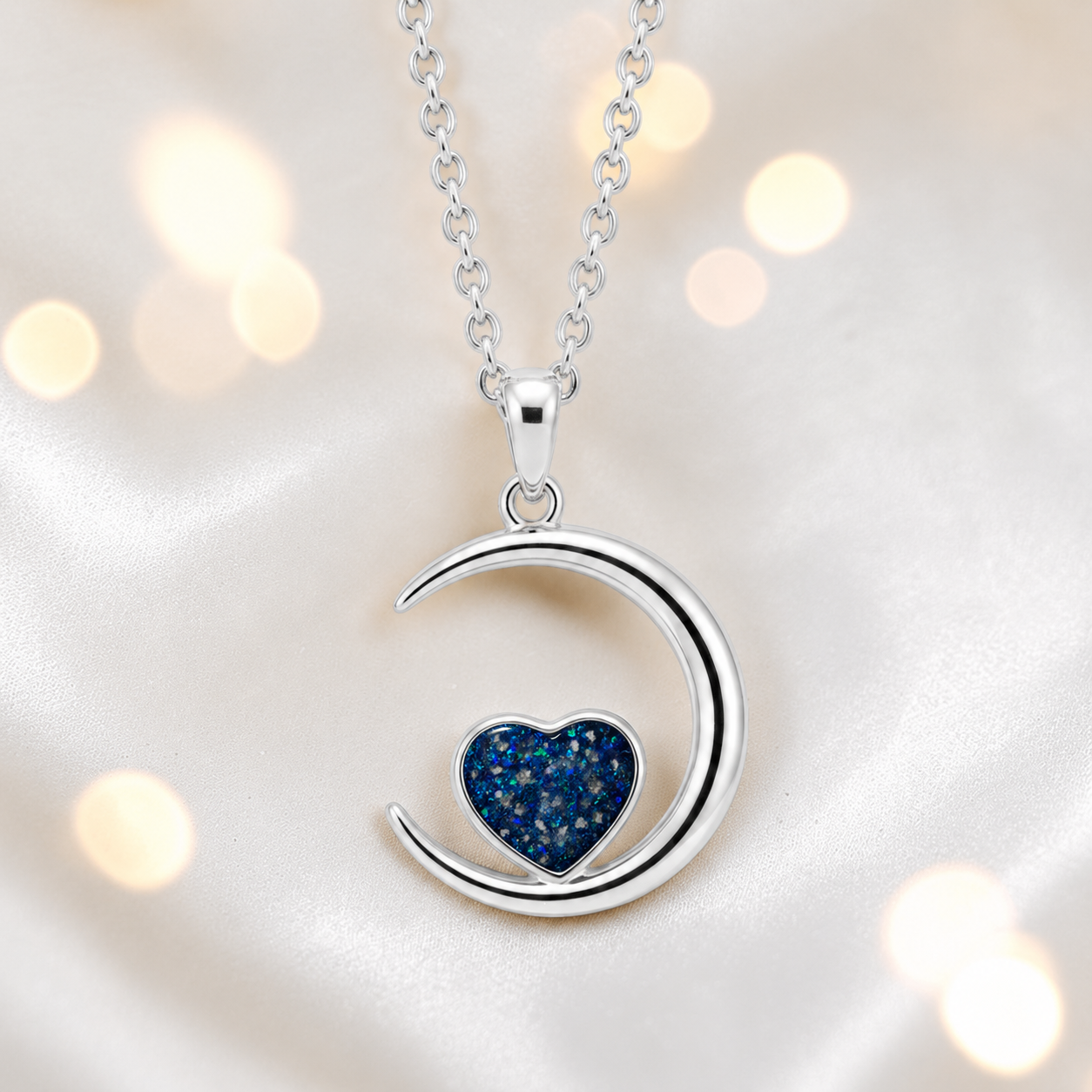 Aveline heart moon ashes pendant in sapphire glow, handcrafted in Lancashire UK