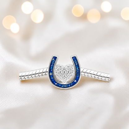 Bella horse shoe ashes charm with CZ heart, in sapphire glow, handmade in Lancashire UK - by Keepsake Memorial Jewellery