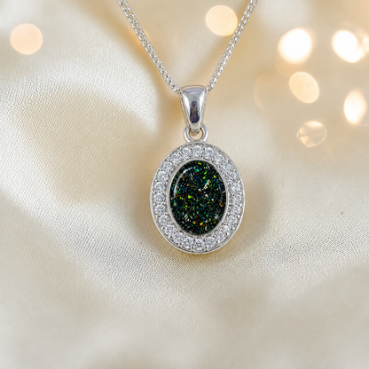 Celae oval ashes pendant in black flame, handcrafted in Lancashire UK