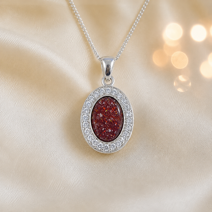 Celae oval ashes pendant in ruby red, handcrafted in Lancashire UK