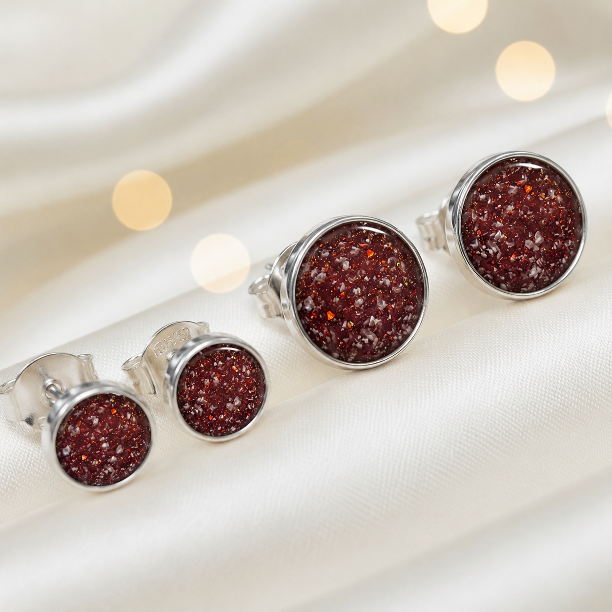 Radiance Earrings — silver round ashes memorial stud earrings in Ruby Red resin, handcrafted in Lancashire, UK