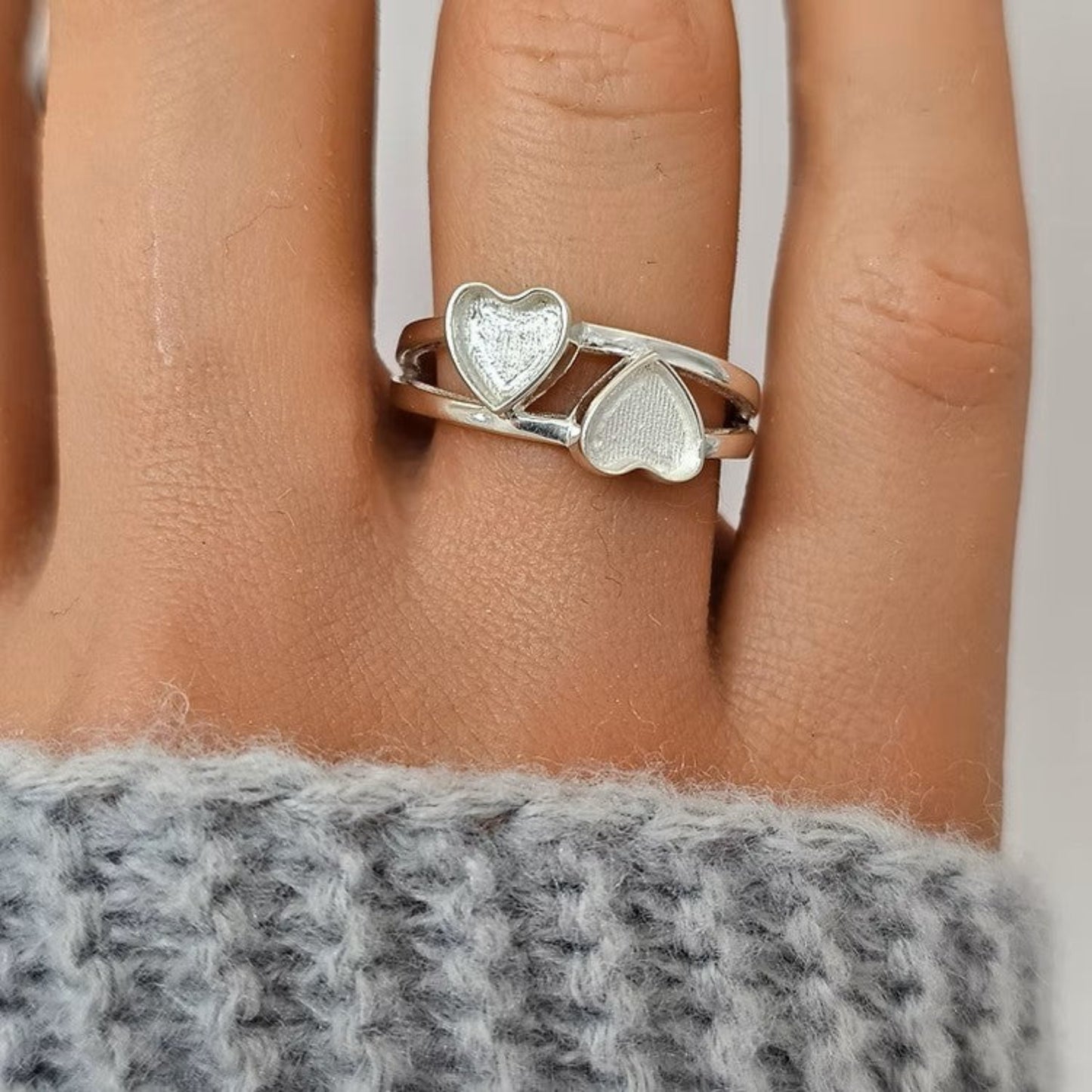 Alouette Ring worn on hand — silver double heart ashes memorial ring, handcrafted in the UK