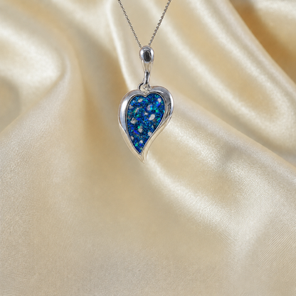 Deneb curved heart silver ashes pendant in sapphire glow, handcrafted in Lancashire UK