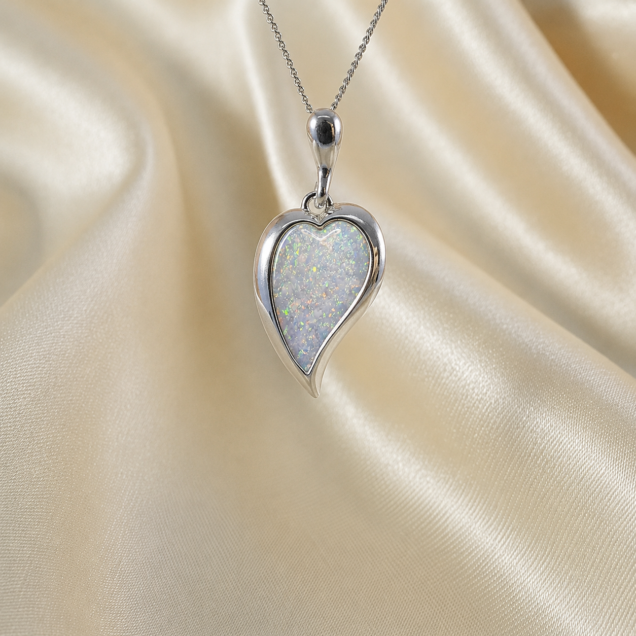 Deneb curved heart silver ashes pendant in white snow, handcrafted in Lancashire UK