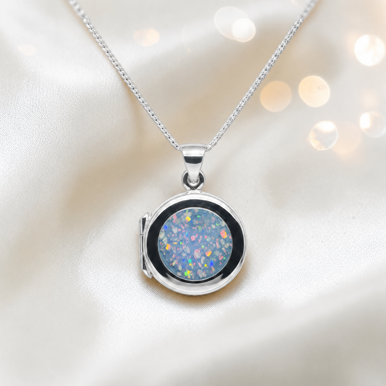 Electra round memorial locket in sterling silver, shown here in baby blue, handcrafted in Lancashire UK - by Keepsake Memorial Jewellery