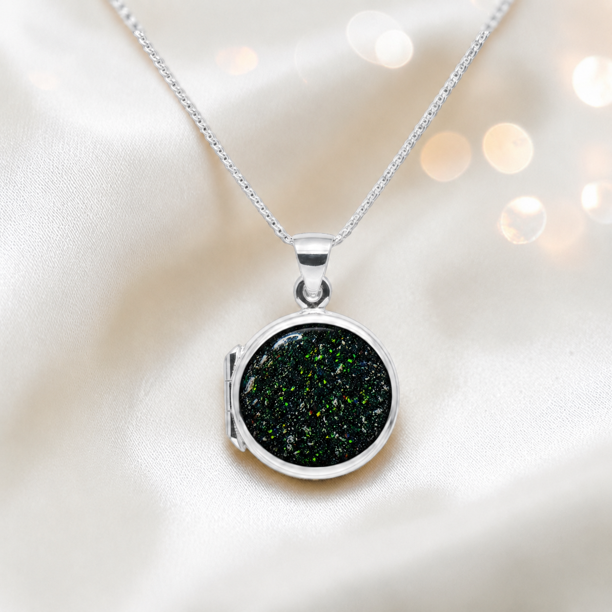 Electra round memorial locket in sterling silver, shown here in black flame, handcrafted in Lancashire UK - by Keepsake Memorial Jewellery