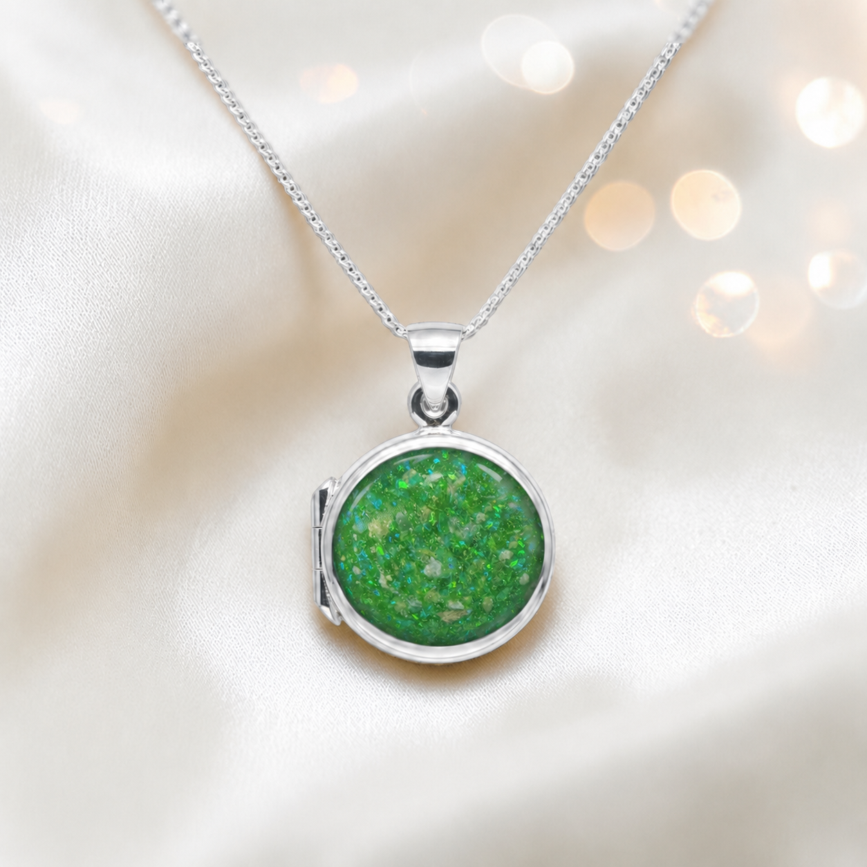 Electra round memorial locket in sterling silver, shown here in fruit green, handcrafted in Lancashire UK - by Keepsake Memorial Jewellery