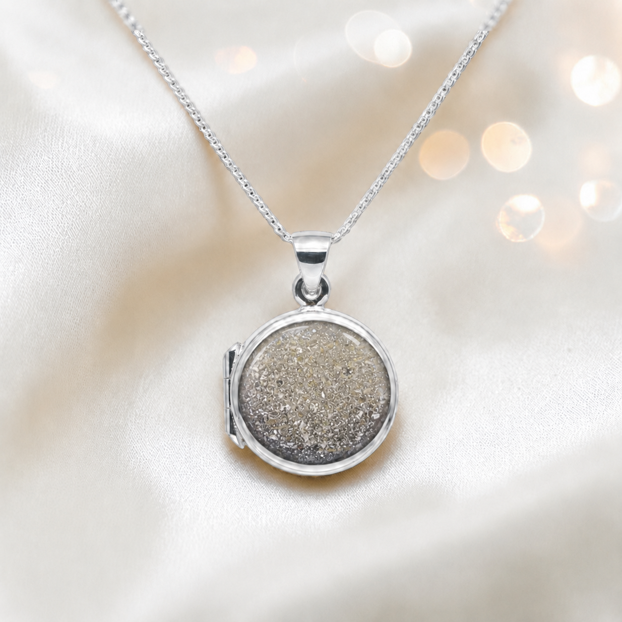 Electra round memorial locket in sterling silver, shown here in natural ash, handcrafted in Lancashire UK - by Keepsake Memorial Jewellery