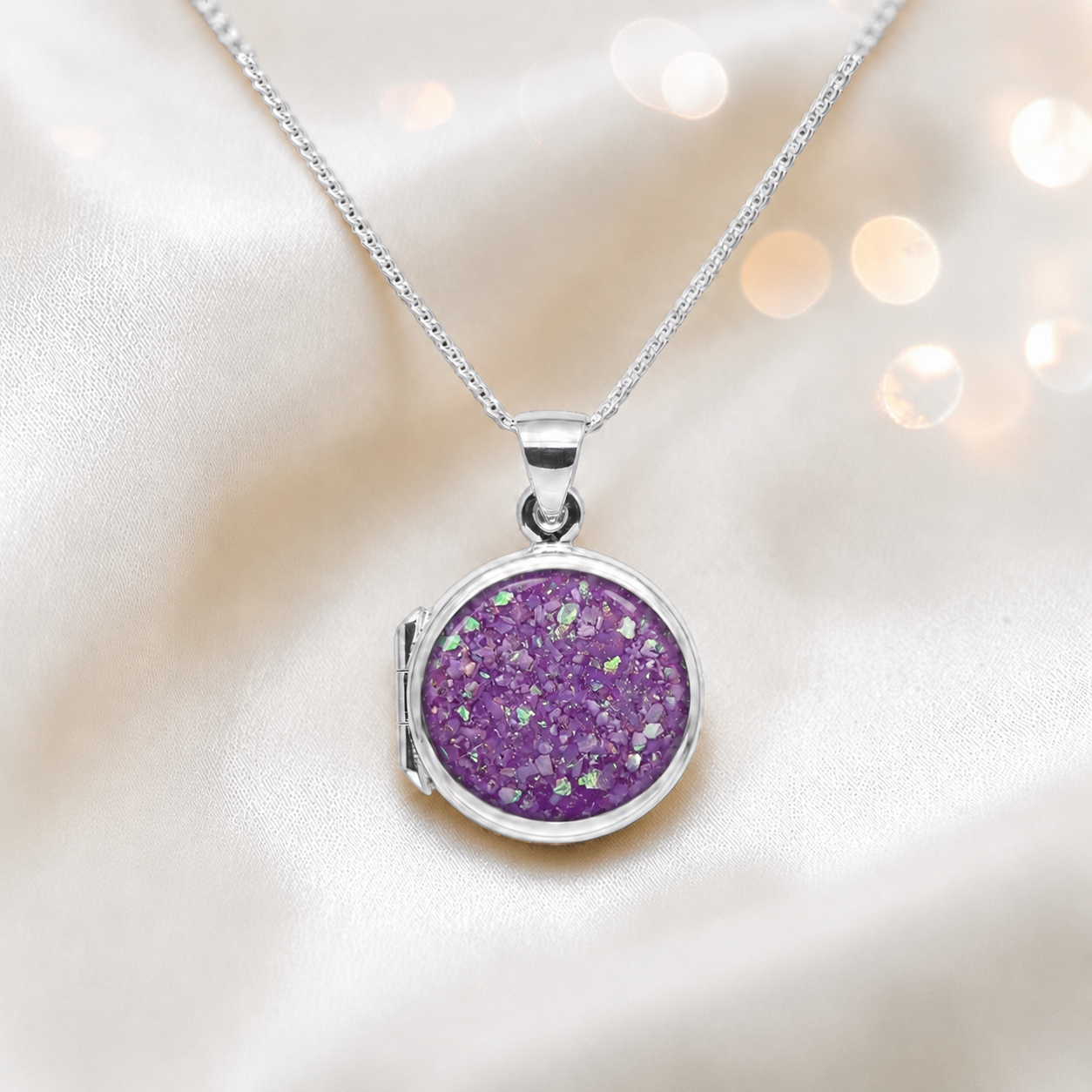 Electra round memorial locket in sterling silver, shown here in rose pink, handcrafted in Lancashire UK - by Keepsake Memorial Jewellery