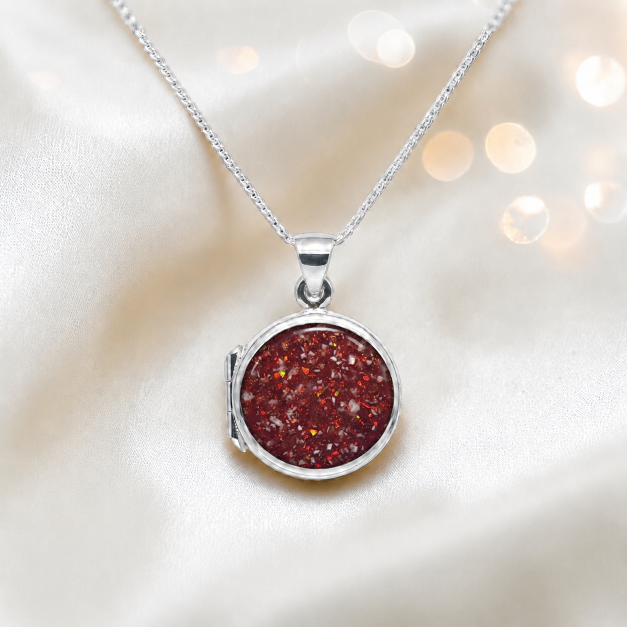 Electra round memorial locket in sterling silver, shown here in ruby red, handcrafted in Lancashire UK - by Keepsake Memorial Jewellery