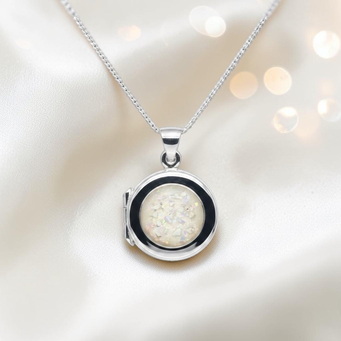 Electra round memorial locket in sterling silver, shown here in white snow, handcrafted in Lancashire UK - by Keepsake Memorial Jewellery