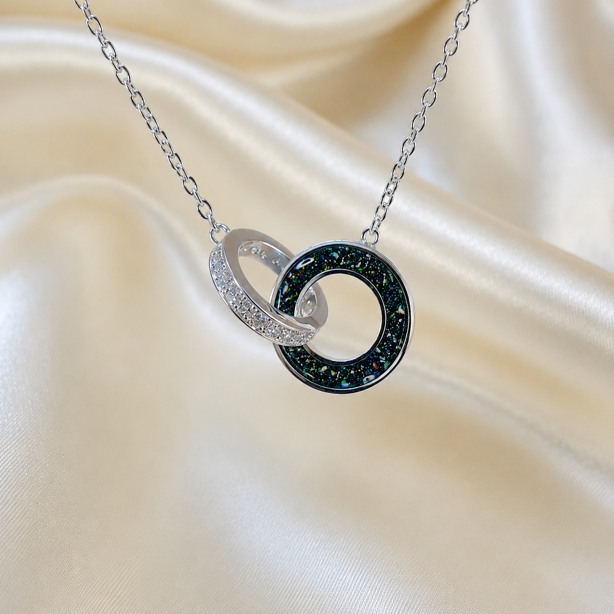 Eternal Embrace Pendant in 925 sterling silver — two interlocking rings with cubic zirconia in black flame. Handcrafted memorial jewellery, made in Lancashire Uk -by Keepsake Memorial Jewellery