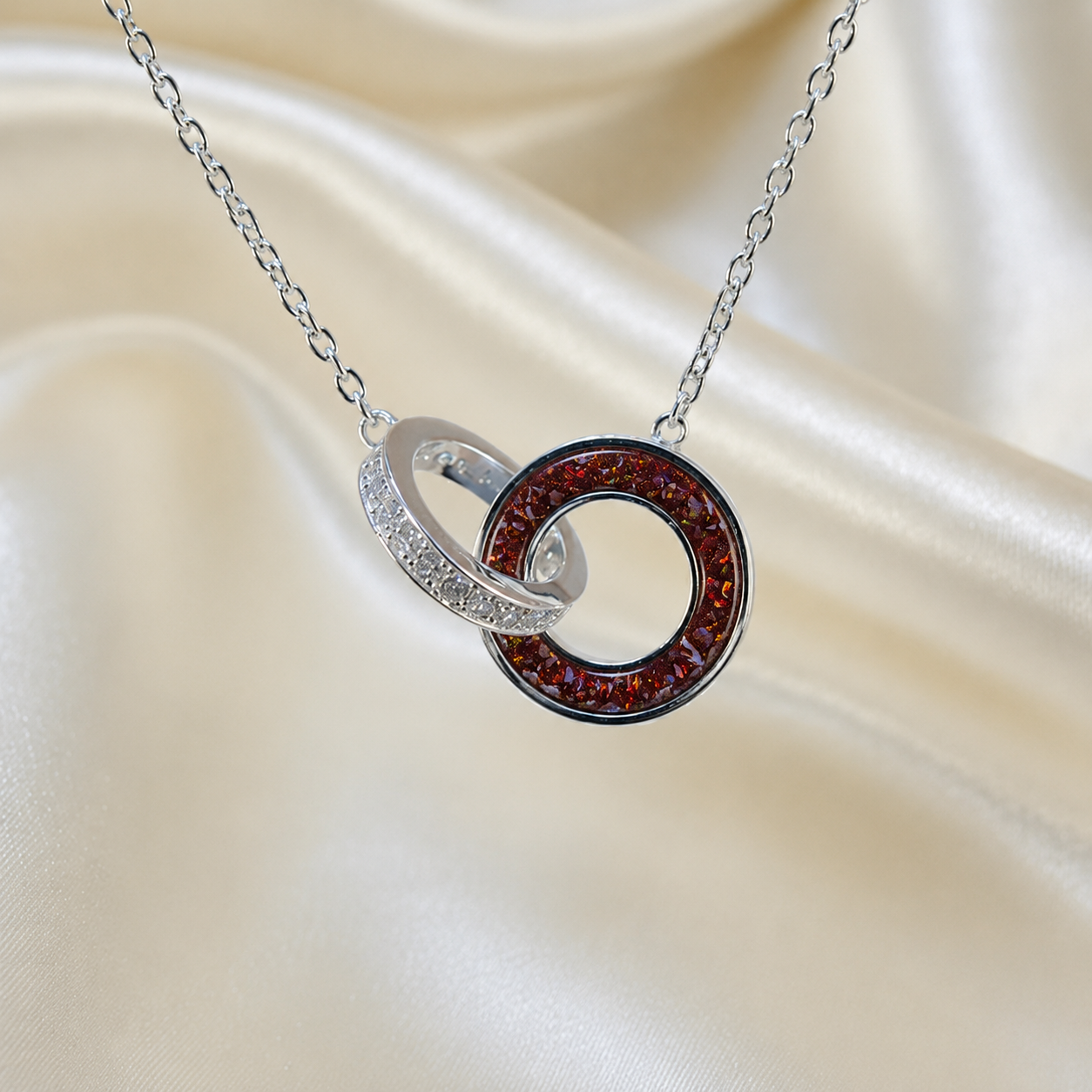 Eternal Embrace Pendant in 925 sterling silver — two interlocking rings with cubic zirconia in copper mocha. Handcrafted memorial jewellery, made in Lancashire Uk -by Keepsake Memorial Jewellery