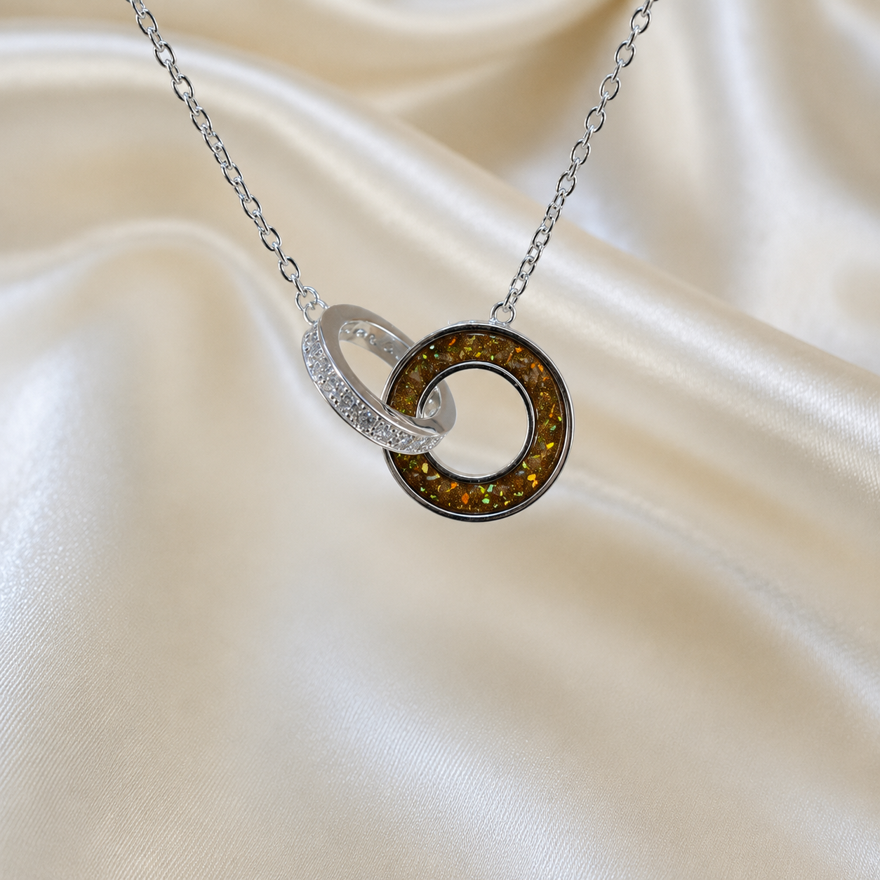 Eternal Embrace Pendant in 925 sterling silver — two interlocking rings with cubic zirconia in gold olive. Handcrafted memorial jewellery, made in Lancashire Uk -by Keepsake Memorial Jewellery
