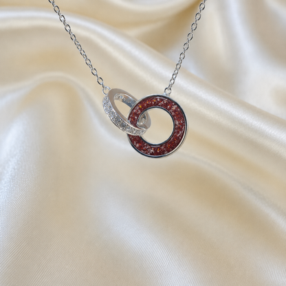 Eternal Embrace Pendant in 925 sterling silver — two interlocking rings with cubic zirconia in ruby red. Handcrafted memorial jewellery, made in Lancashire Uk -by Keepsake Memorial Jewellery