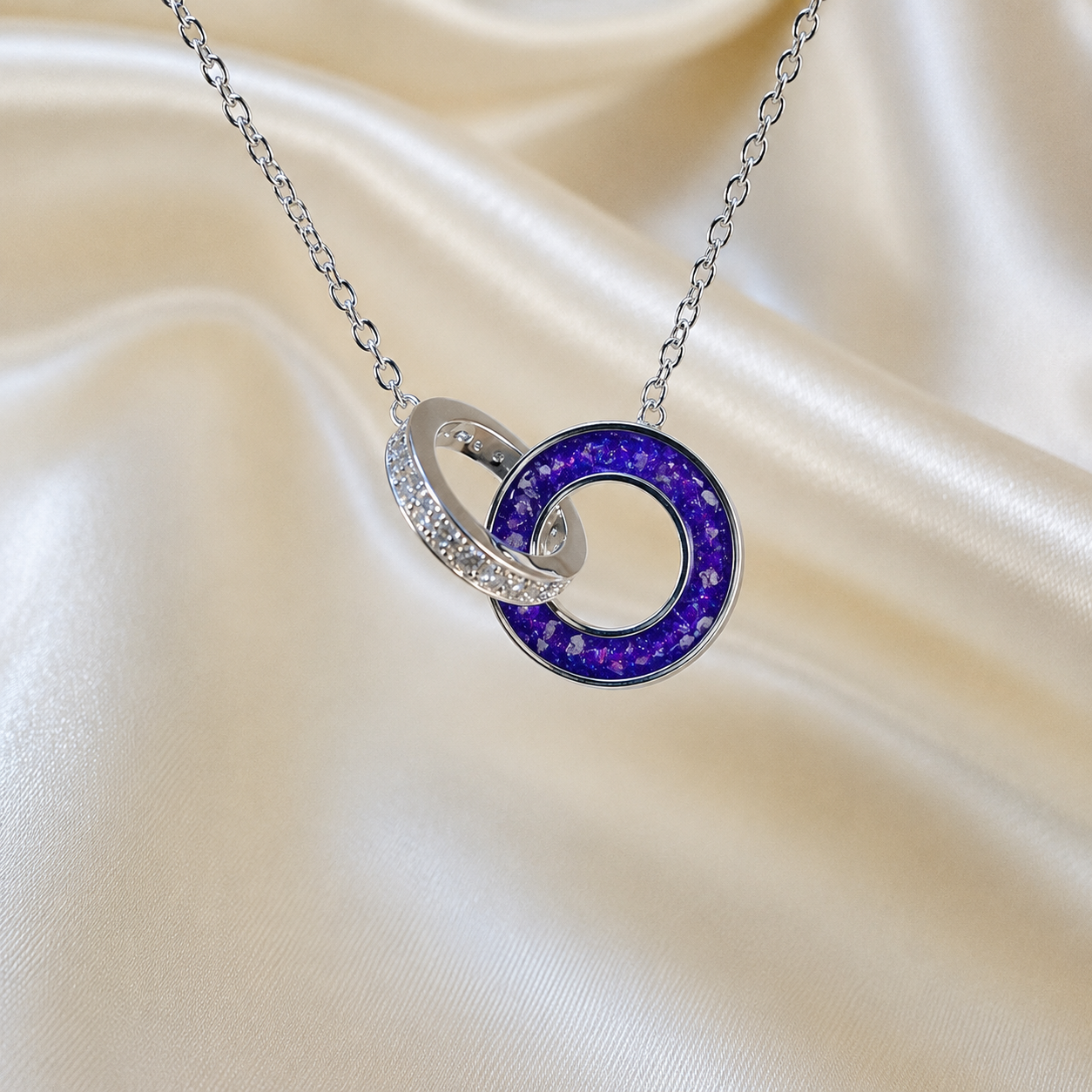 Eternal Embrace Pendant in 925 sterling silver — two interlocking rings with cubic zirconia in sleepy lavender. Handcrafted memorial jewellery, made in Lancashire Uk -by Keepsake Memorial Jewellery