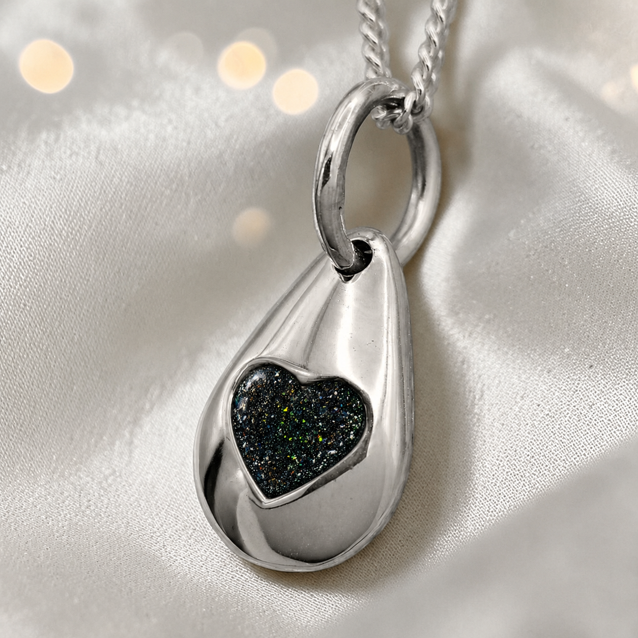 Gacrux pebble shaped pendant with heart memorial stone in black flame, handcrafted in Lancashire UK - by Keepsake Memorial Jewellery