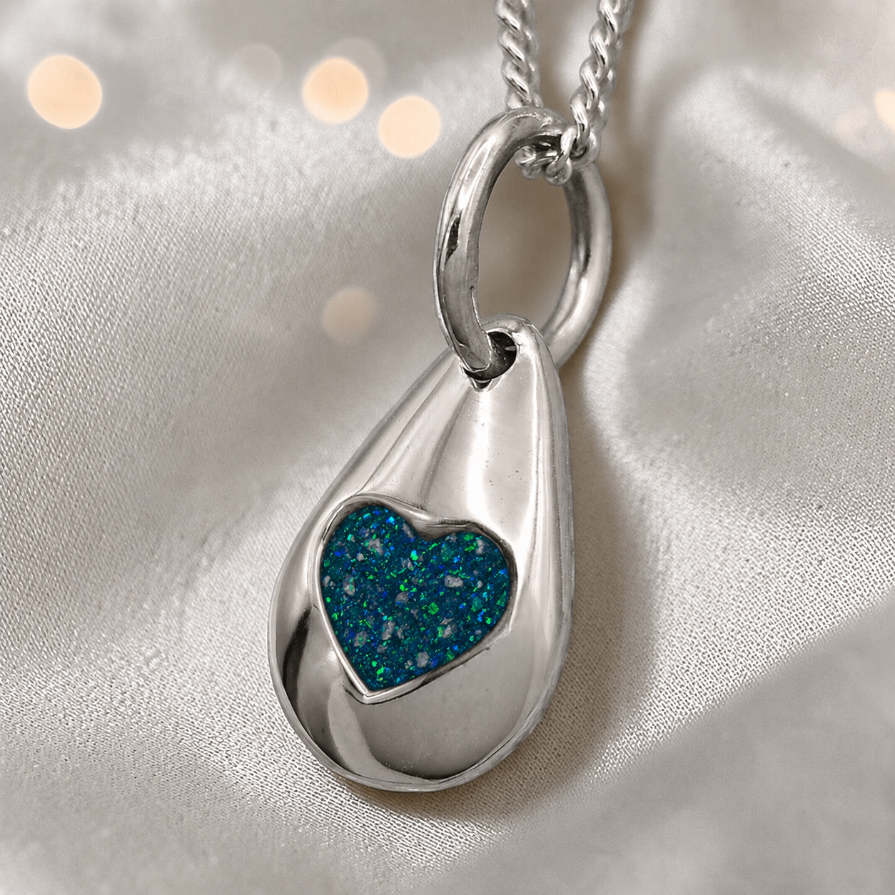 Gacrux pebble shaped pendant with heart memorial stone in teal mist, handcrafted in Lancashire UK - by Keepsake Memorial Jewellery