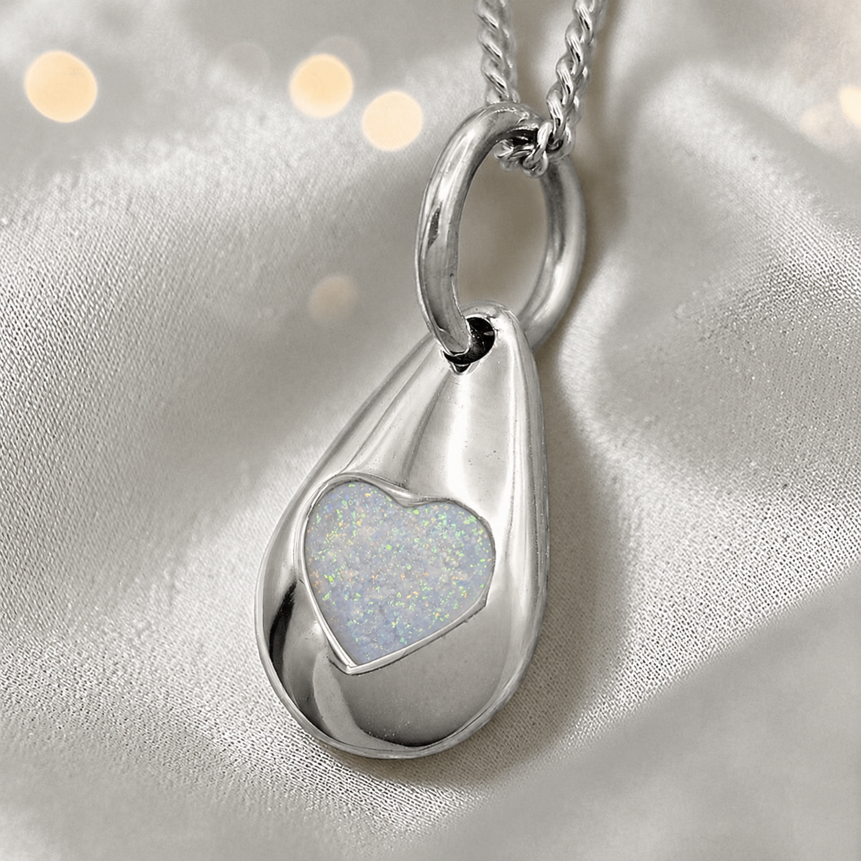 Gacrux pebble shaped pendant with heart memorial stone in white snow, handcrafted in Lancashire UK - by Keepsake Memorial Jewellery