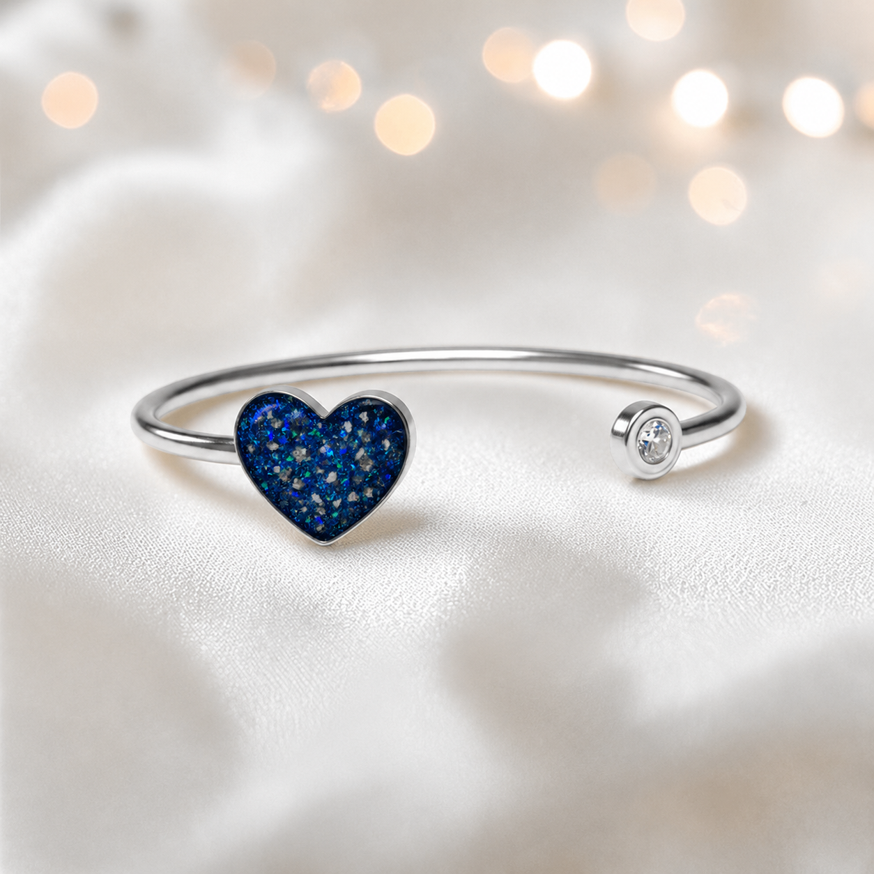 Halcyon Bangle — silver heart ashes memorial bangle in sapphire glow, handcrafted in Lancashire, UK - by Keepsake memorial Jewellery