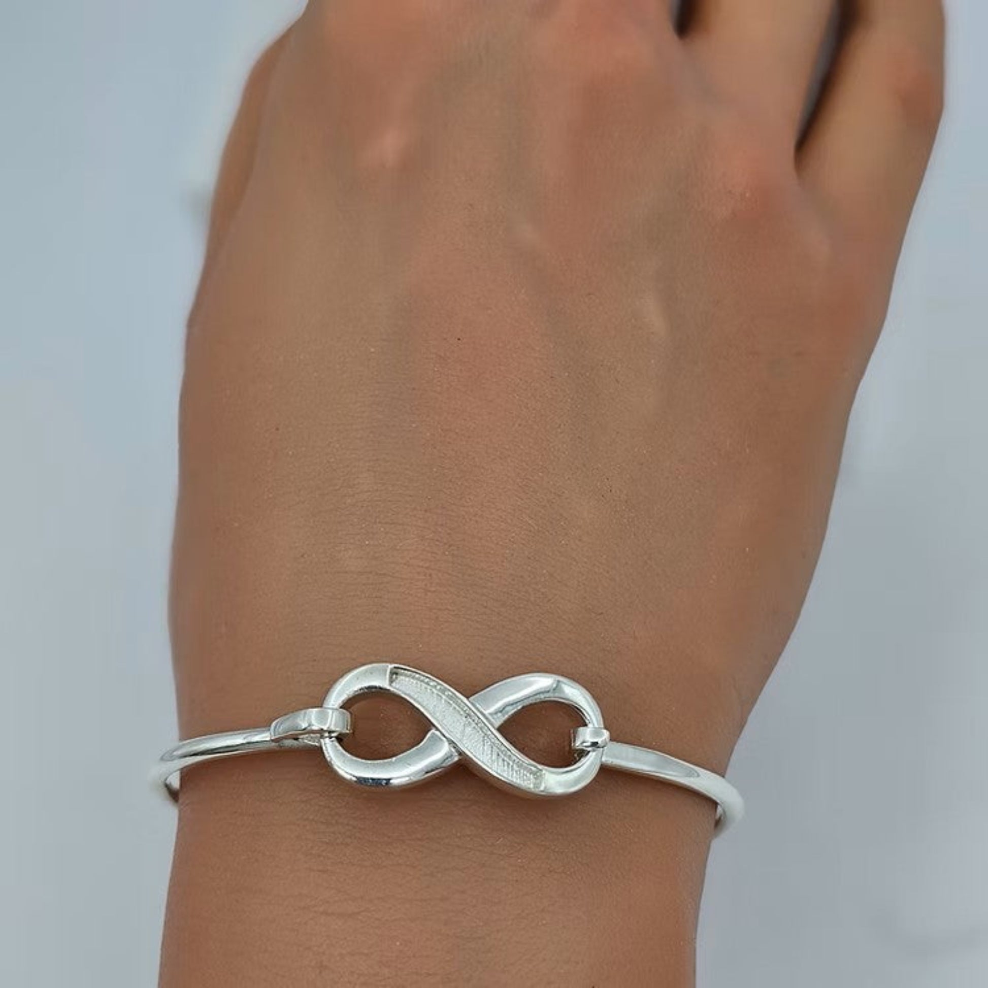 Lunara Bangle — silver infinity clasp ashes memorial bangle worn on wrist, handcrafted in Lancashire, UK